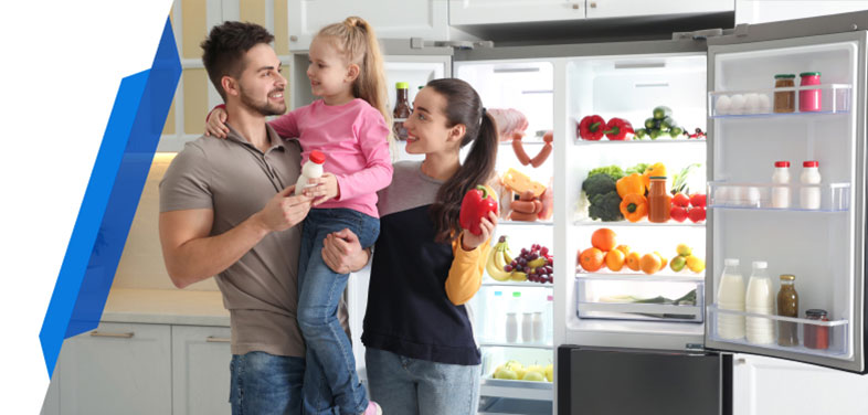Happy family near open fridge filled with fresh fruits and vegetables – Fridge freezer Insurance protection