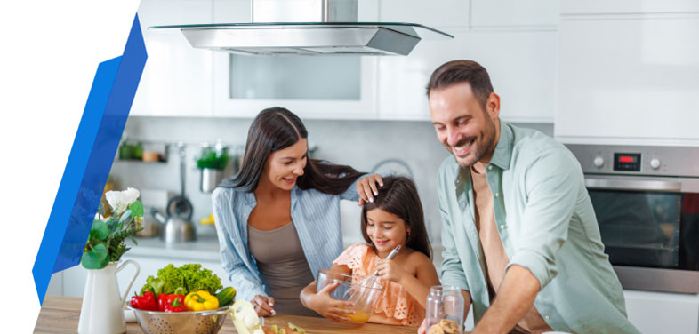 Happy family using kitchen appliances together, representing appliance insurance protection for everyday essentials