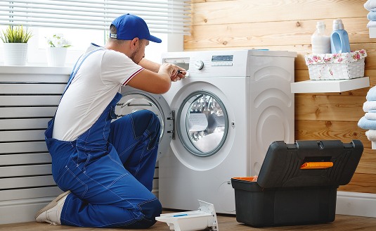Happy family using kitchen appliances together, representing appliance insurance protection for everyday essentials
