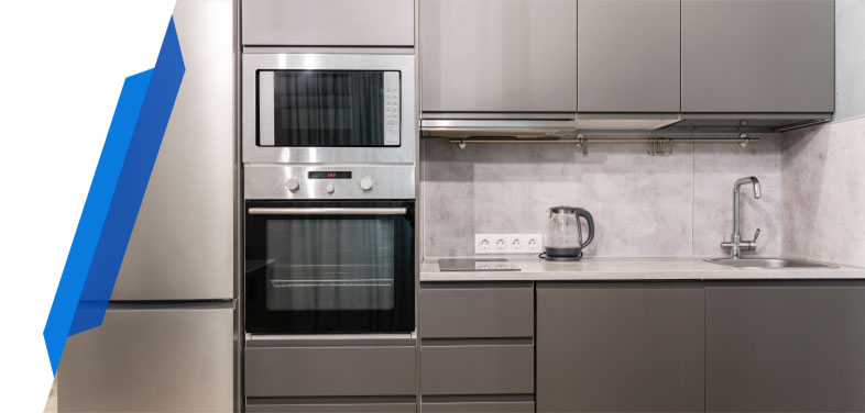 Built-in electric oven with a baking tray being inserted