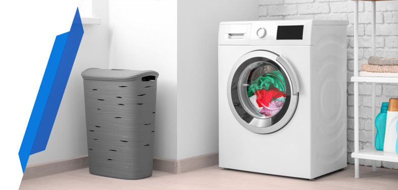 Washing machine with laundry basket in a utility room — covered under Smart Cover washer dryer insurance.