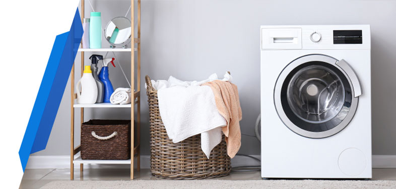 Front-loading washing machine in a laundry room with clothes baskets
