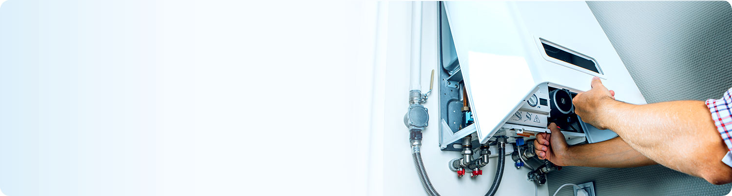 Technician repairing a boiler, representing landlord cover for home emergency and maintenance protection