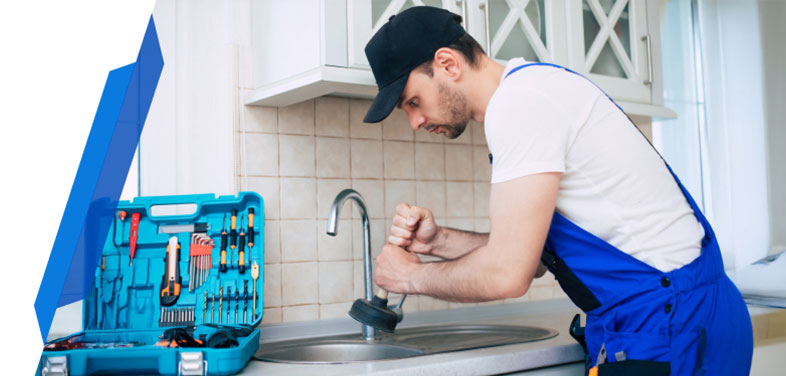 Blocked drain being cleared by a smart cover professional plumber