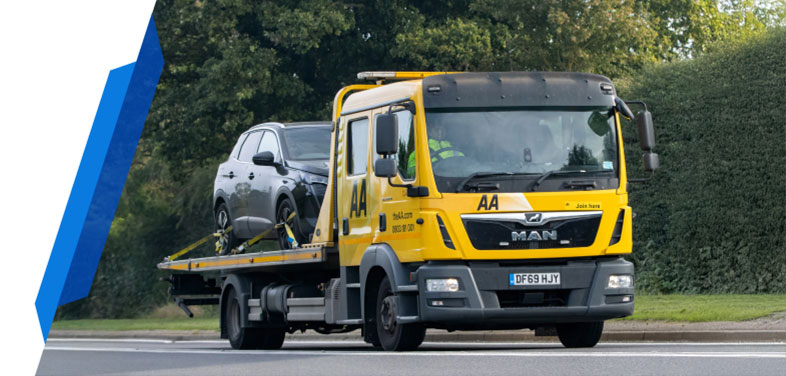 A black taxi car being carried by a yellow recovery truck, covered by a Smart Cover taxi car breakdown insurance policy