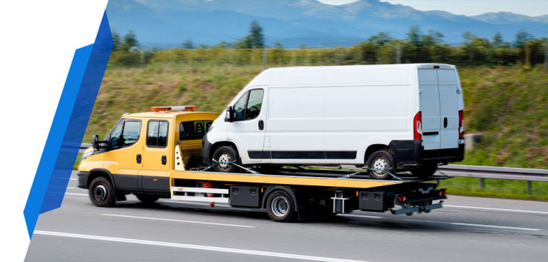 Yellow recovery truck transporting a broken-down van  with smart cover van breakdown insurance policy